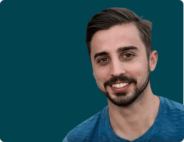 A smiling man in a blue T-shirt
