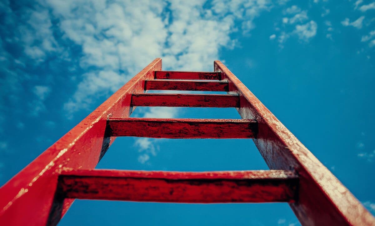 Red ladder leading up to the sky, signifying how to identify high potential employees