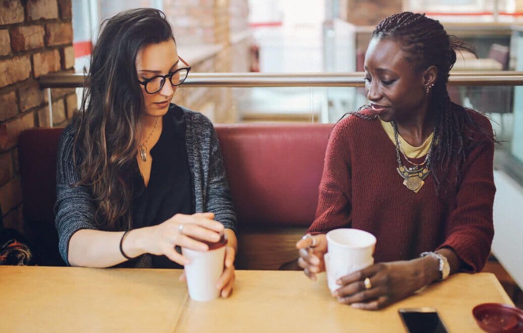 Mentor and mentee talking one-on-one over coffee