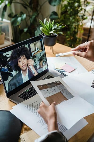 woman in home office on a virtual call with HR leader discussing upskilling employee program