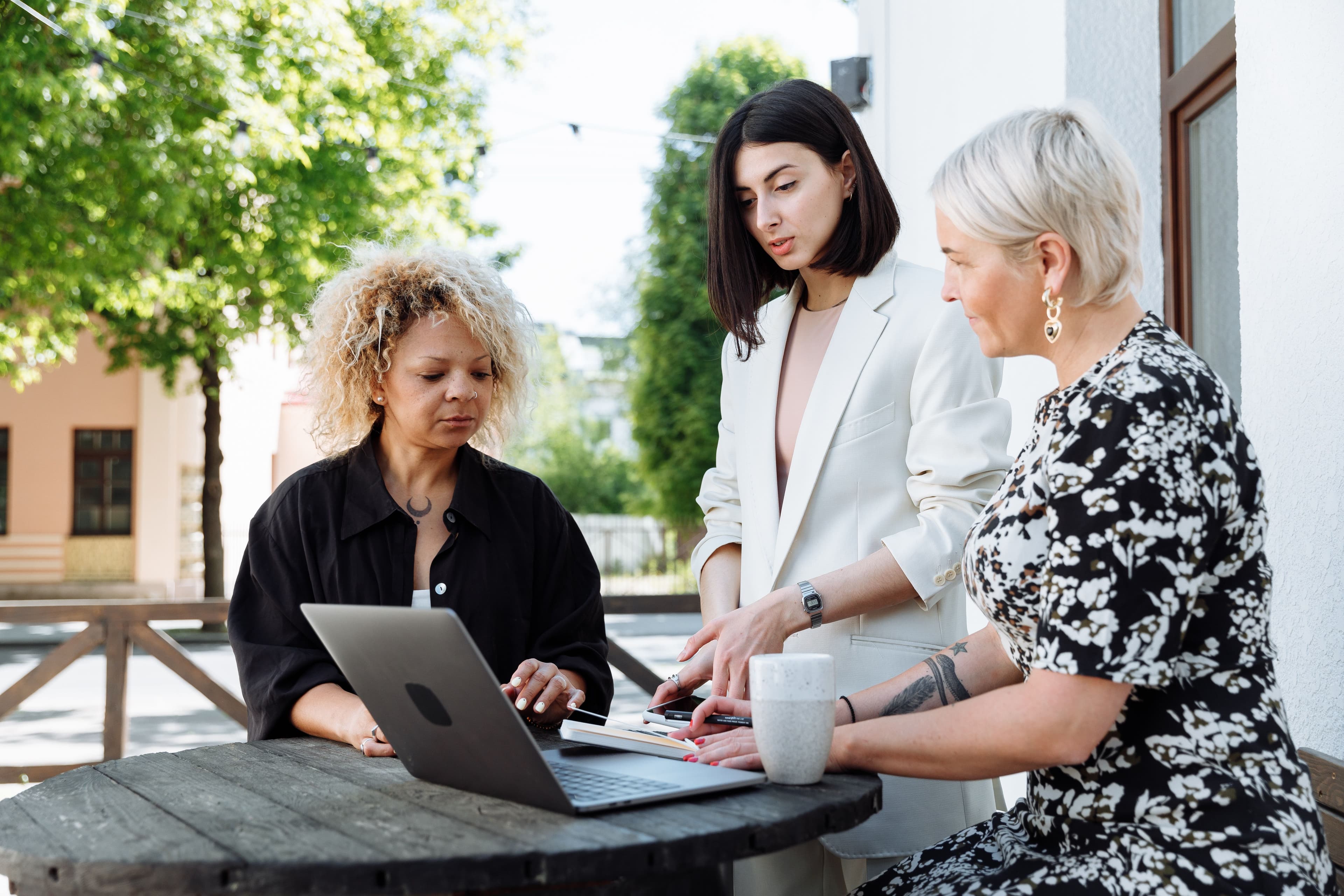 three women in a new hire onboarding buddy program
