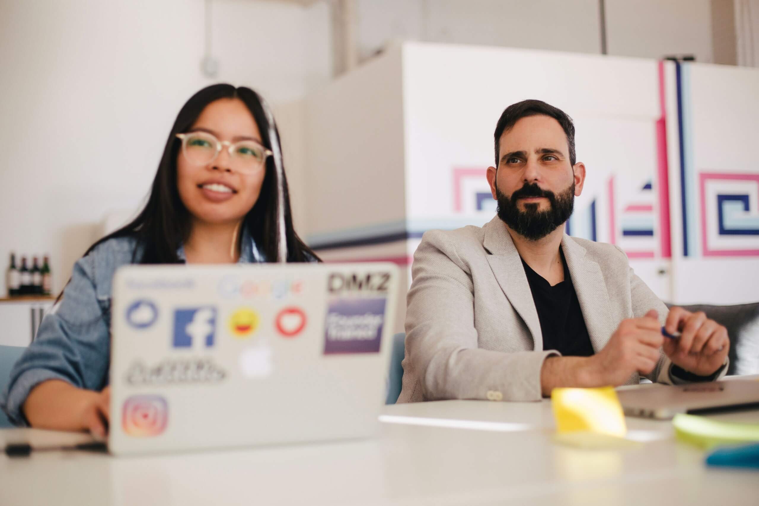Employees working together at a shared desk